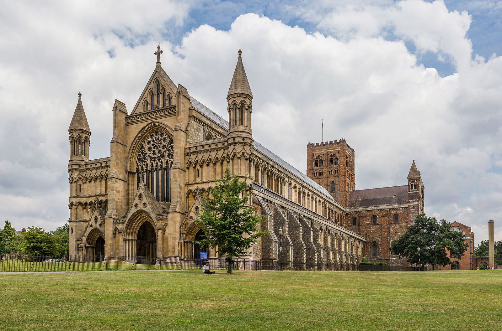 The west front of St Albans Cathedral in afternoon light, four minutes on foot from the Photiades office at Longmire House on London Road.